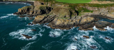 Coastline view waves crashing against cliffs