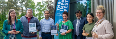 Dr Joseph Burchell (second from left) accepting the award at The Impact Festival 